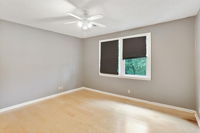 unfurnished room with light wood-style flooring, baseboards, ceiling fan, and a textured ceiling