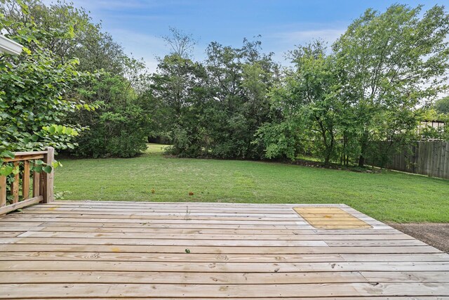 deck featuring a yard and fence