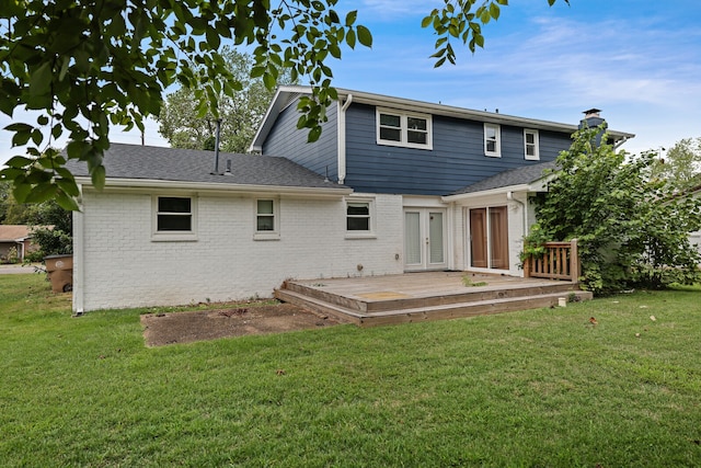 rear view of property with a wooden deck and a yard