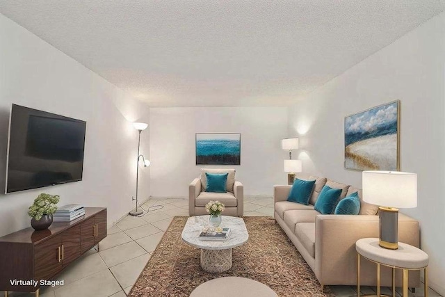 living room featuring a textured ceiling and light tile patterned floors