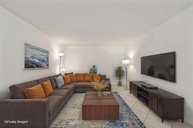 living area with a textured ceiling and light tile patterned flooring