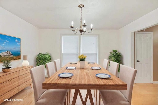 dining room featuring an inviting chandelier and light wood-type flooring