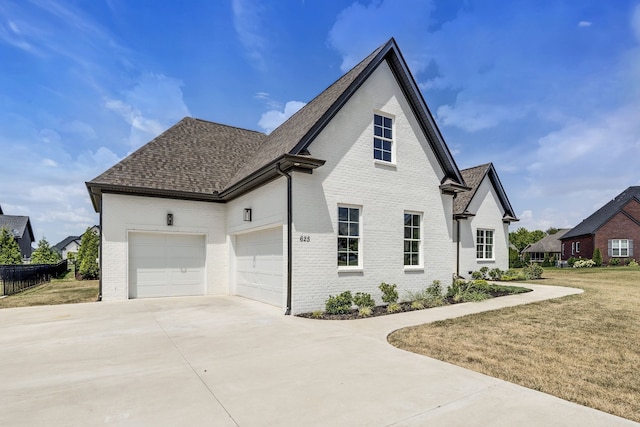 view of front of home featuring a garage and a front lawn