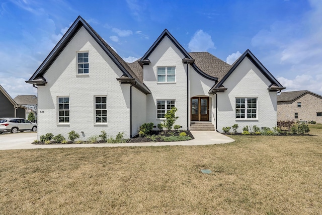 french provincial home featuring a front yard