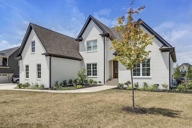 view of front of house with a garage and a front yard