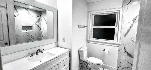 bathroom featuring vanity, toilet, and walk in shower