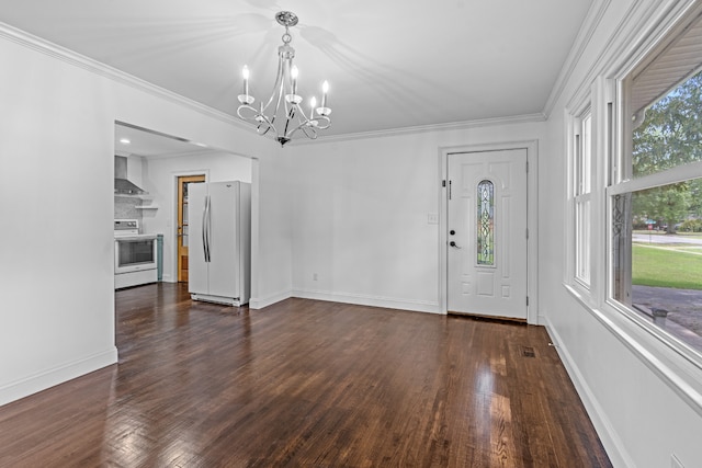 interior space featuring dark wood-type flooring, ornamental molding, and a notable chandelier