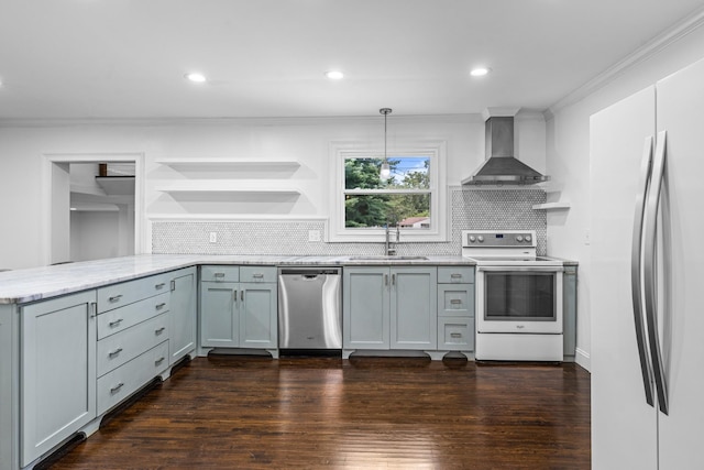 kitchen featuring stainless steel appliances, a peninsula, hanging light fixtures, wall chimney range hood, and open shelves