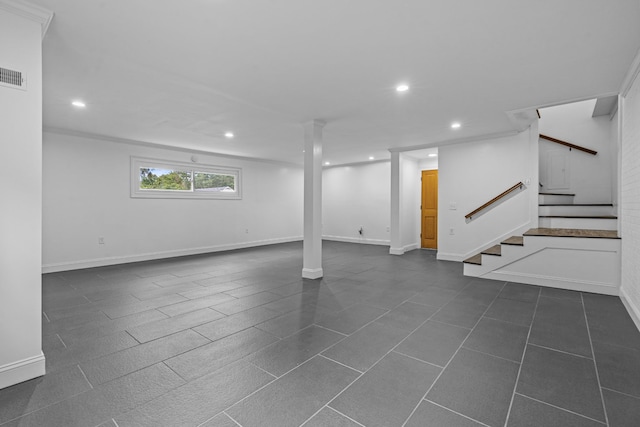 basement featuring baseboards, stairway, and recessed lighting