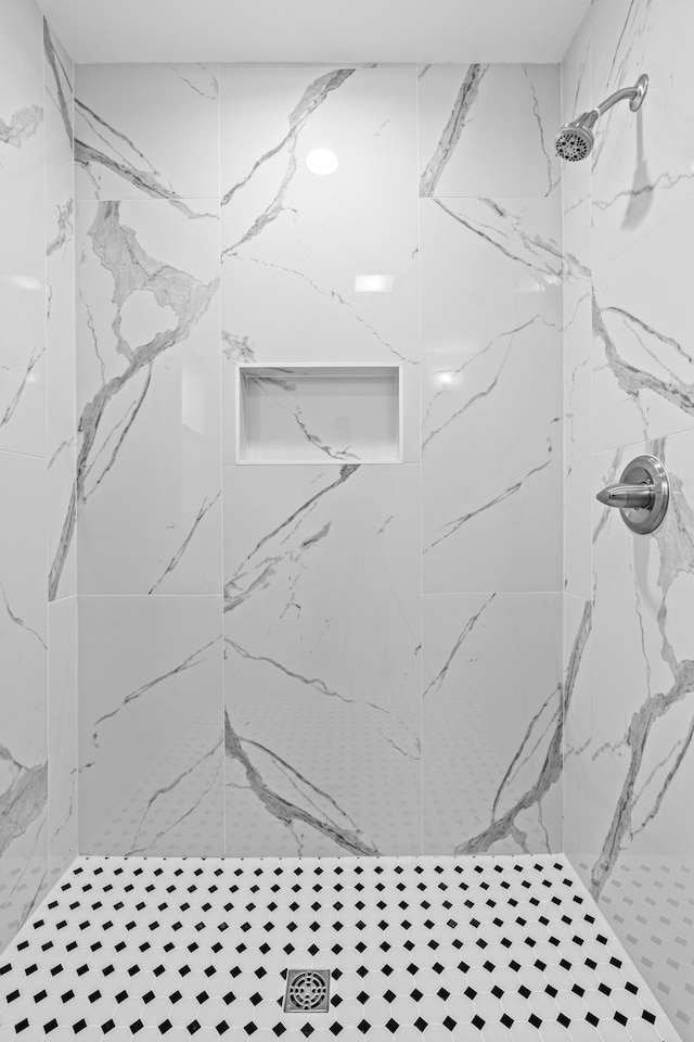 room details featuring a marble finish shower