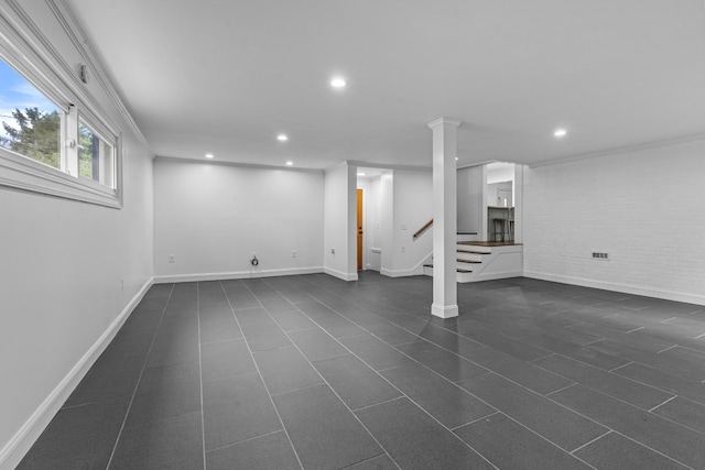 below grade area with recessed lighting, stairway, ornamental molding, brick wall, and baseboards