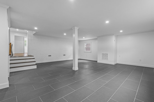 basement with crown molding and brick wall