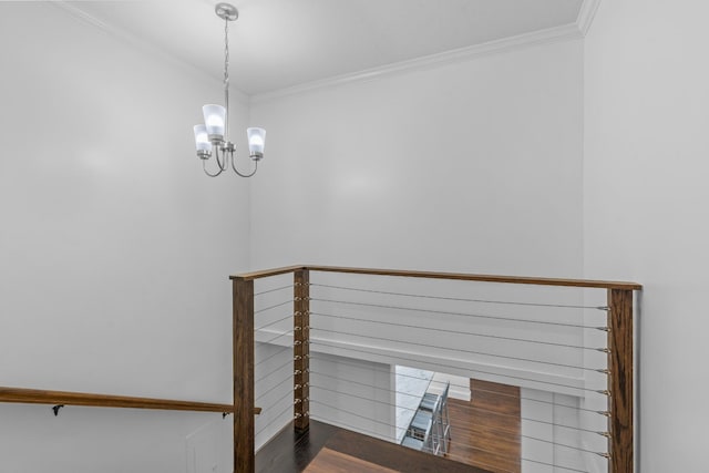 stairs featuring ornamental molding, wood finished floors, and a notable chandelier