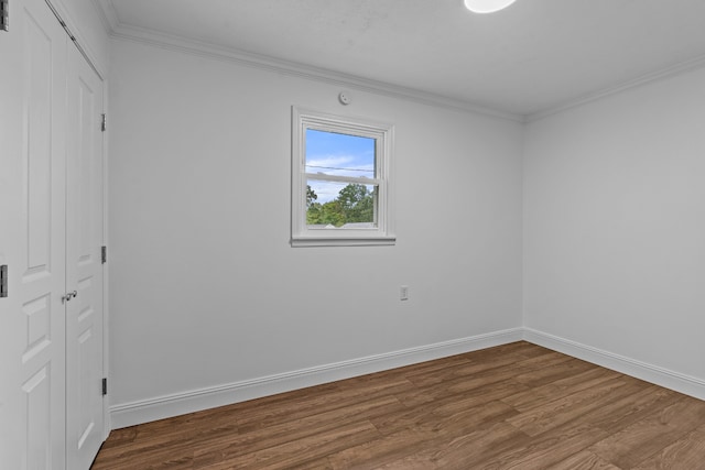 unfurnished room featuring hardwood / wood-style floors and ornamental molding