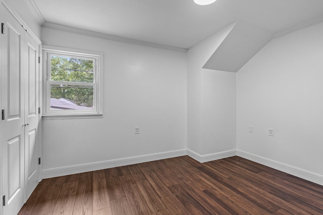 bonus room featuring dark wood-type flooring and baseboards