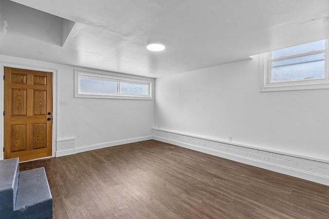 below grade area with dark wood finished floors and baseboards