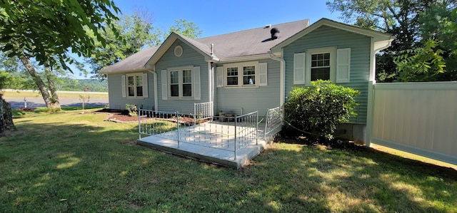 rear view of house with a yard