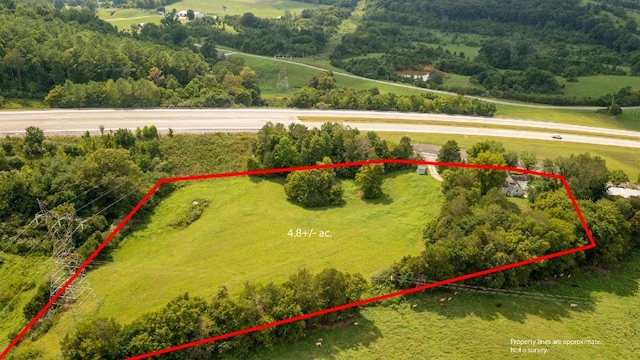 birds eye view of property with a rural view