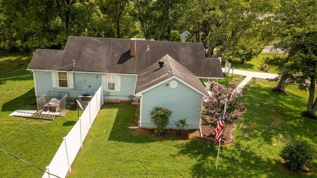 rear view of property featuring a yard