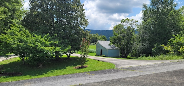 exterior space with a front lawn and an outdoor structure