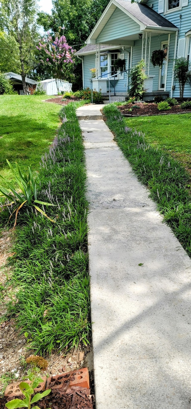 exterior space with a porch and a front lawn