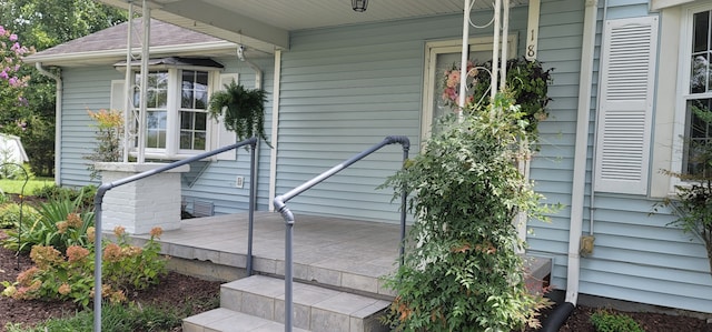 view of exterior entry with covered porch