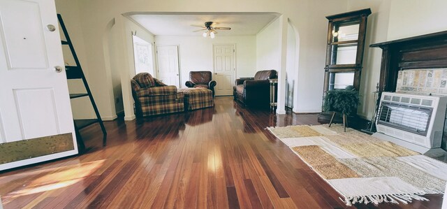 interior space featuring ceiling fan, ornamental molding, and dark hardwood / wood-style flooring