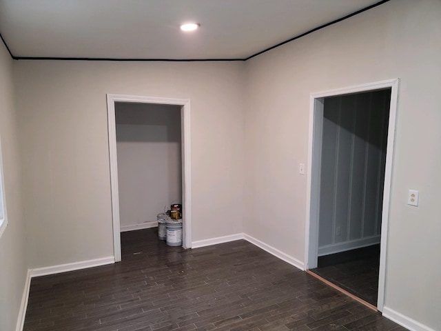 spare room featuring dark wood-type flooring