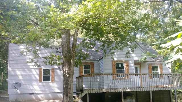 back of house with a deck