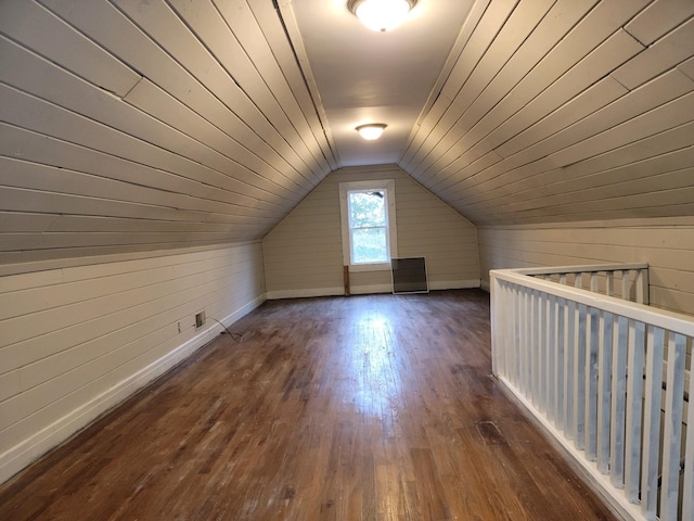 bonus room with lofted ceiling, dark wood-type flooring, wooden walls, and wood ceiling