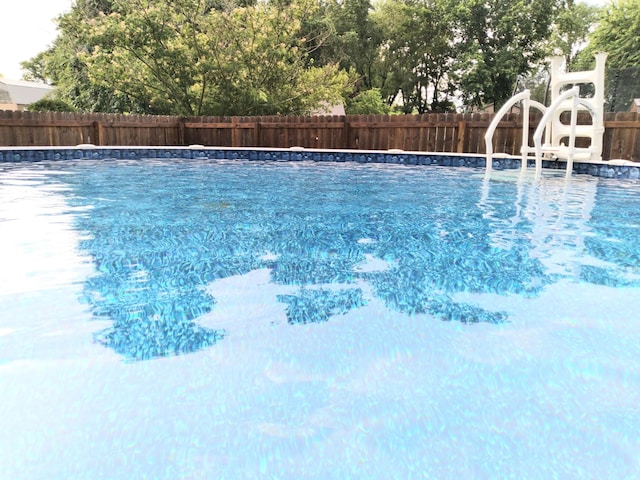 view of swimming pool with fence and a fenced in pool