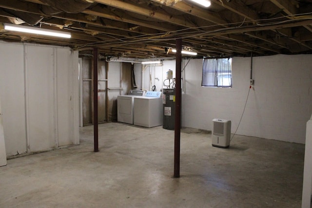 basement with washing machine and dryer and electric water heater