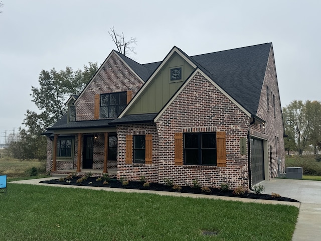 view of front of home featuring a garage, a front yard, and a porch