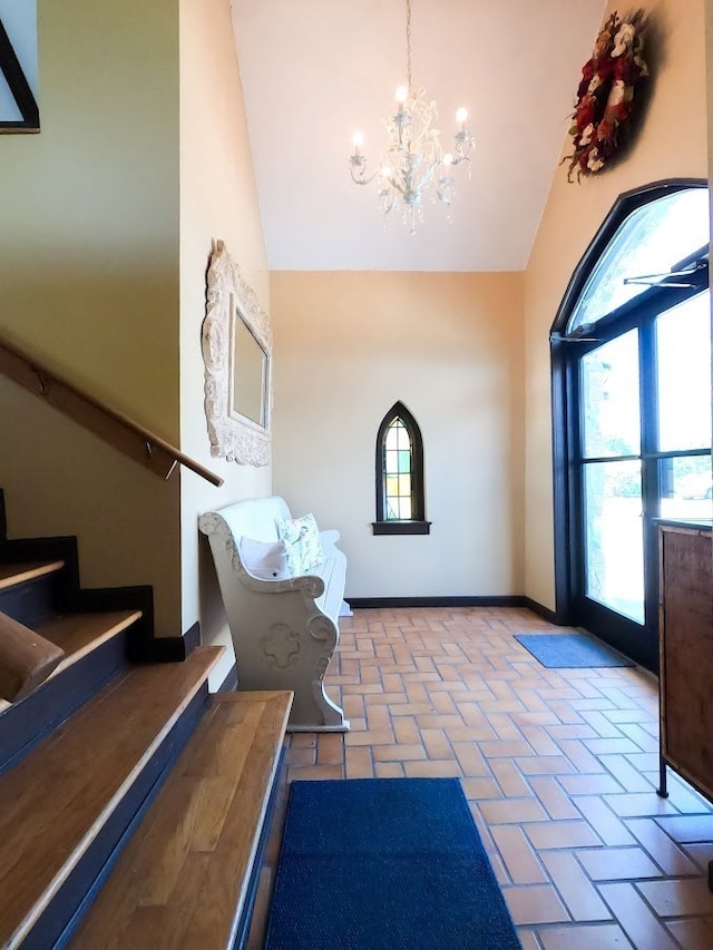 interior space with an inviting chandelier and lofted ceiling