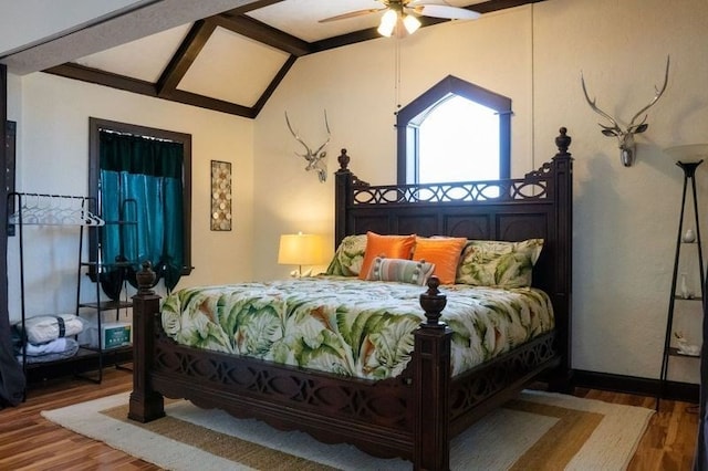 bedroom featuring lofted ceiling with beams, hardwood / wood-style flooring, and ceiling fan