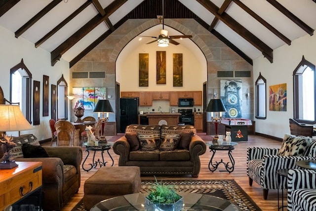 living room with beamed ceiling, wood-type flooring, ceiling fan, and high vaulted ceiling