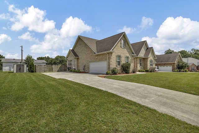 view of front of home featuring a storage unit, a garage, and a front lawn