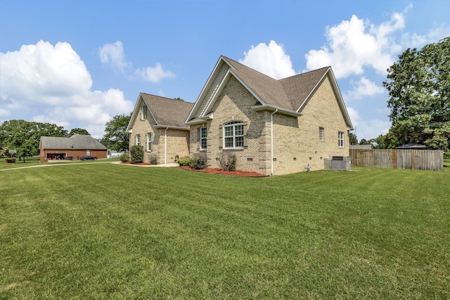 view of side of home with cooling unit and a lawn