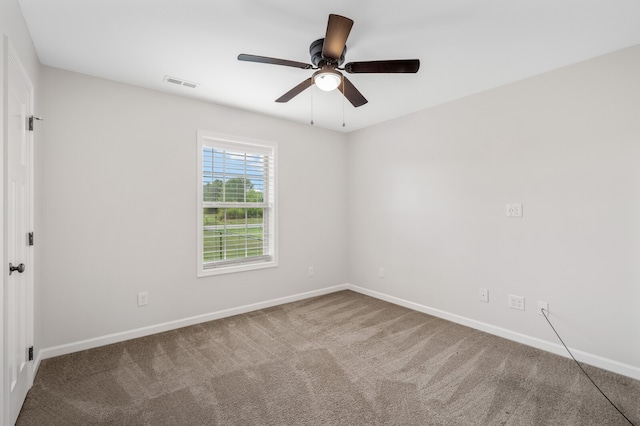 empty room featuring carpet floors and ceiling fan