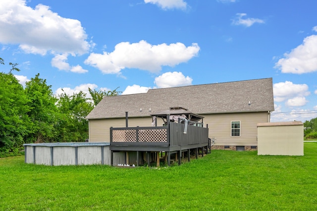 rear view of house with a deck and a yard