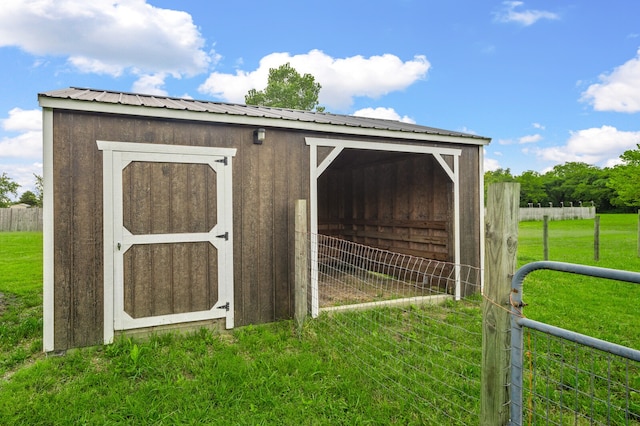 view of outbuilding with a yard