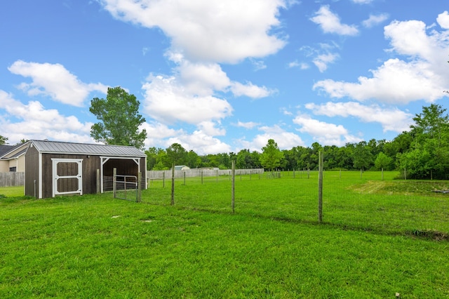 view of yard featuring a rural view and an outdoor structure