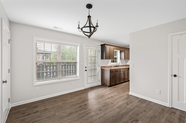 interior space featuring a notable chandelier, dark hardwood / wood-style flooring, and sink