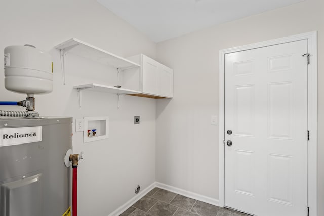 laundry room featuring electric water heater, hookup for a washing machine, electric dryer hookup, and dark tile patterned flooring