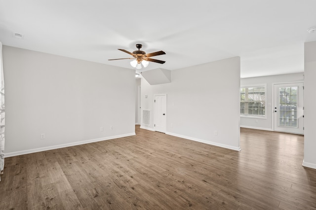 unfurnished living room featuring ceiling fan and hardwood / wood-style floors