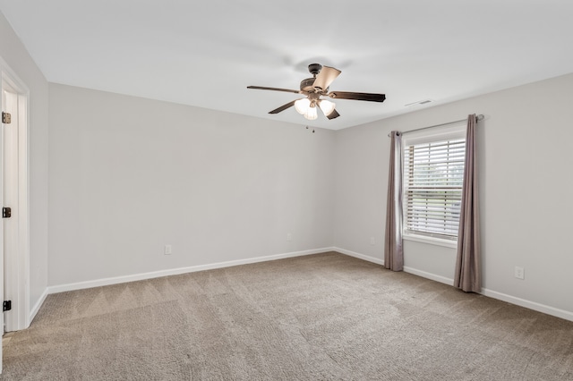 carpeted empty room featuring ceiling fan