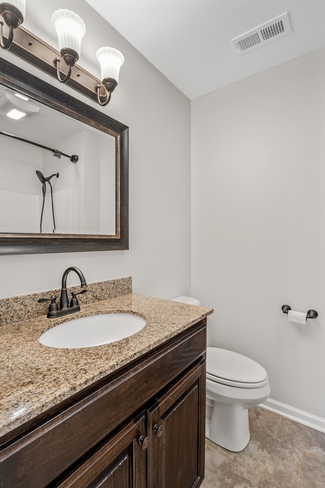 bathroom with vanity, tile patterned flooring, and toilet