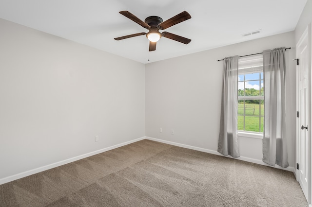 empty room featuring light carpet and ceiling fan