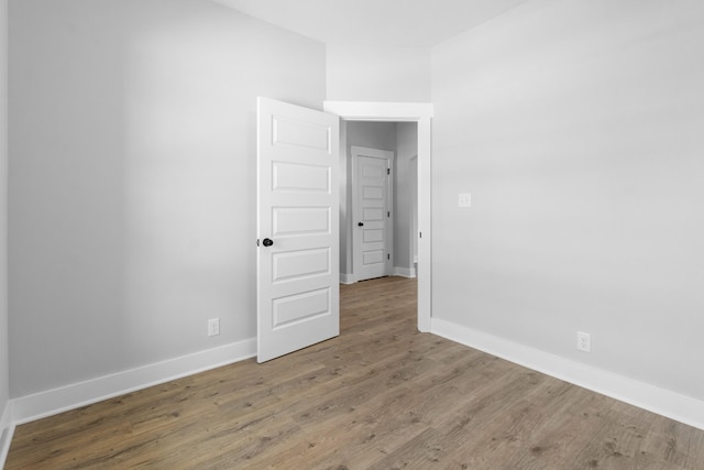 unfurnished room with hardwood / wood-style floors