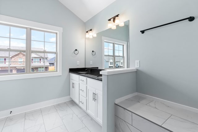 bathroom featuring lofted ceiling and vanity